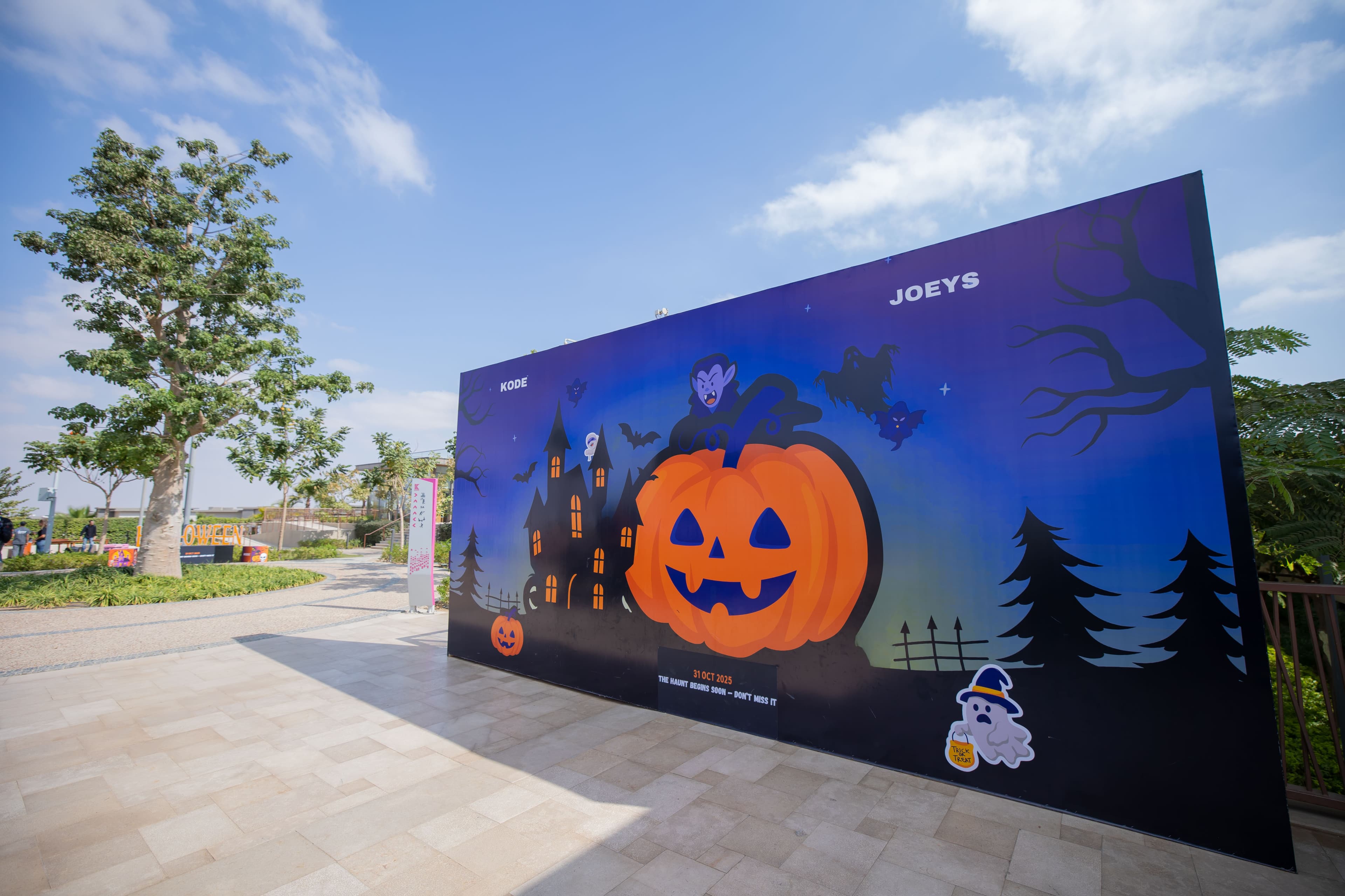 A large illustrated Halloween welcome wall at KODE Club