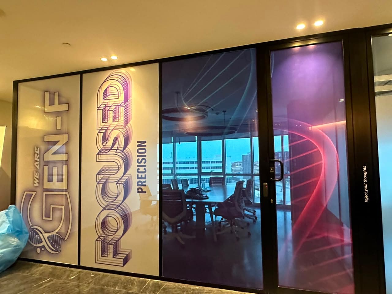 Pharco GEN-F graphics installed across a glass meeting-room wall